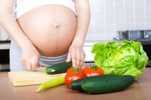 Pregnancy and nutrition - pregnant woman with vegetables
